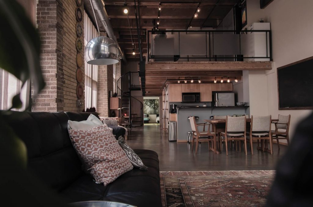 Typical industrial loft with dark furniture and industrial elements.